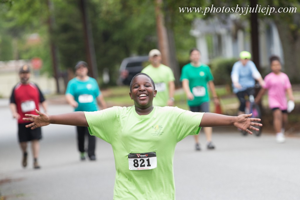 5K Race of Boy Smiling with arms stretched wide