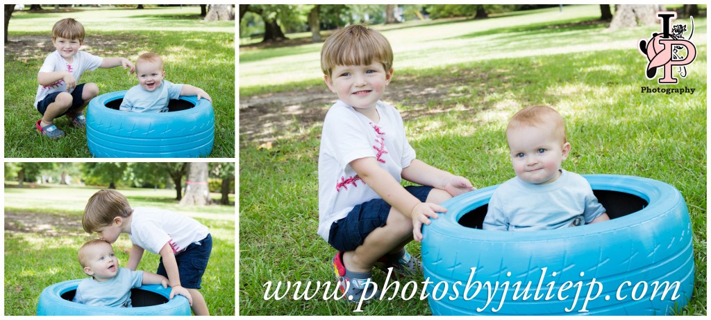 Siblings sitting on painted blue tire