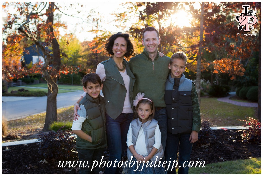 family portrait in front of fall leaves